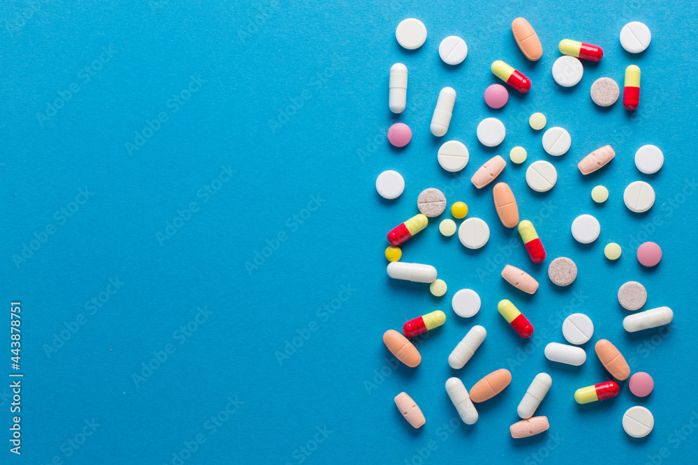 pills, vitamins, capsules on a blue background