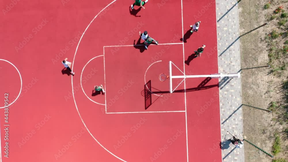 Aerial view of young athletes throwing the ball into the basketball