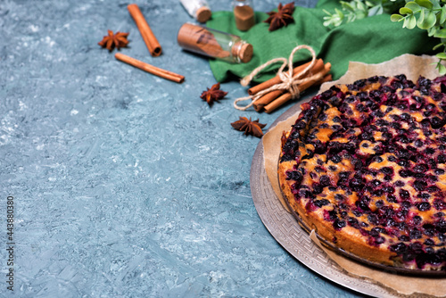 Traditional french pie clafouti with black currants cherries.
