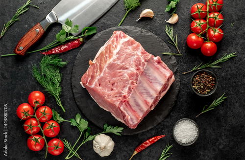 Raw whole pork steaks with ribs on stone background