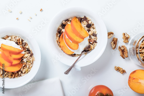 Homemade vegan granola cereal with soy yogurt, walnuts, fuji apple and almond milk. photo