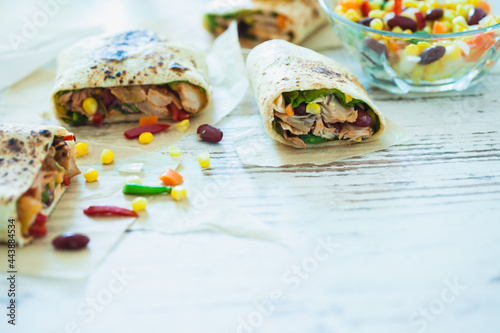 Traditional Mexican Food -  Burrito, on white wooden retro table
