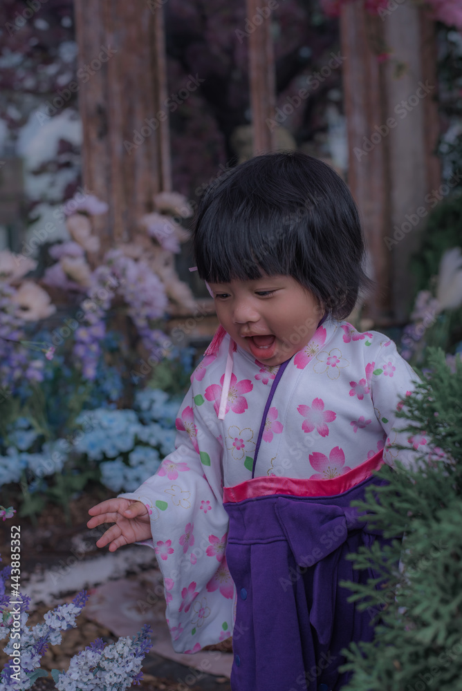 Adorable little girl wearing Japanese kimono in the park with soft focus. Adorable little girl wearing Japanese kimono in the park with soft focus.