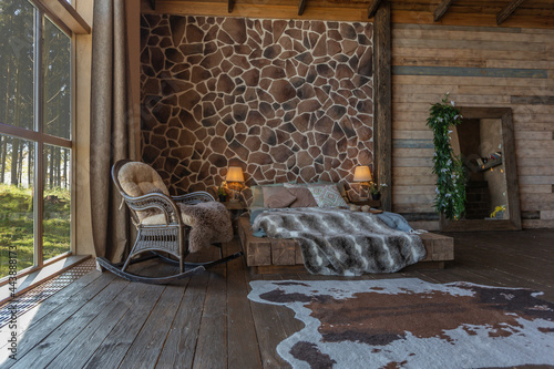 Canvas-taulu dark cozy interior of big country wooden house, wooden furniture and animal furs