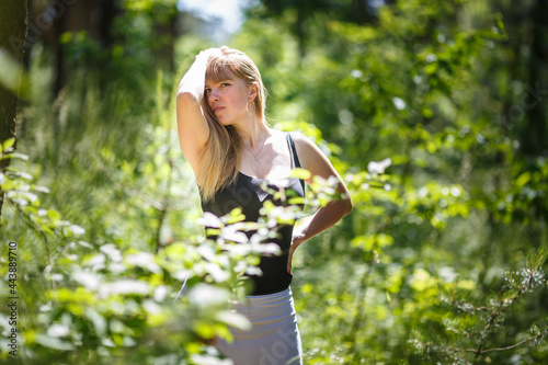 beautiful girl stands in thicket of forest
