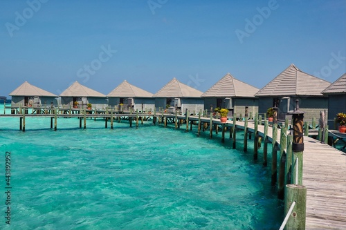 Idyllic Wooden Water Villa with Pier and Lagoon in Maldivian Resort. Beautiful Overwater Bungalow and Turquoise Ocean in Maldives.