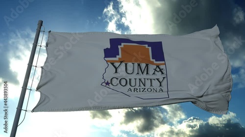Yuma county flag, state of Arizona, United States of America waving at wind in blue sky
