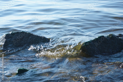 A small wave running on stones
