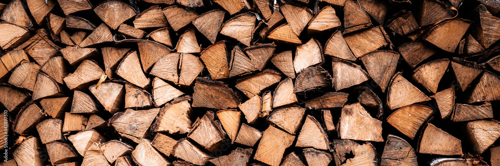 textured firewood background of chopped wood for kindling and heating the house. a woodpile with stacked firewood. the texture of the birch tree. banner textured firewood background of chopped wood for kindling and heating the house. a woodpile with stacked firewood. the texture of the birch tree. banner