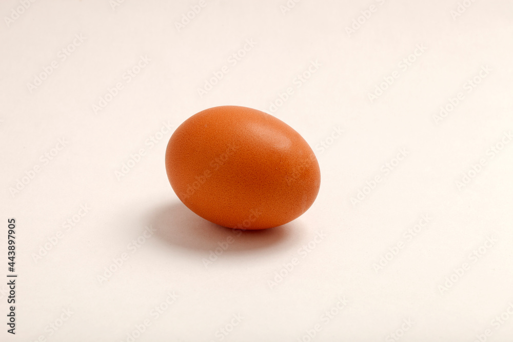Chicken egg, brown in color.