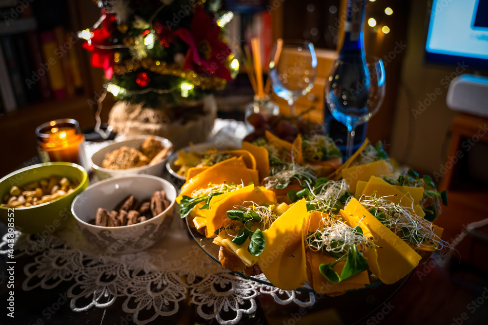 Snacks for wine on the buffet table. Cold snacks such as cookies, nuts, sandwiches with salmon and cheese and nachos. Party snacks table showing christmas or new year celebration concept Snacks for wine on the buffet table. Cold snacks such as cookies, nuts, sandwiches with salmon and cheese and nachos. Party snacks table showing christmas or new year celebration concept
