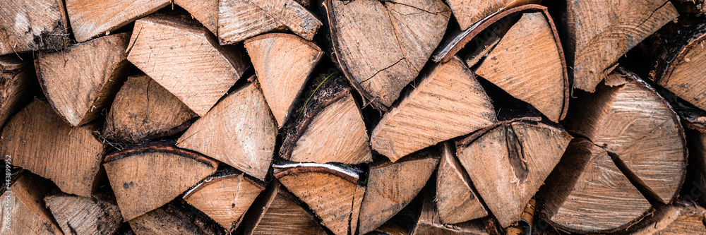 textured firewood background of chopped wood for kindling and heating the house. a woodpile with stacked firewood. the texture of the birch tree textured firewood background of chopped wood for kindling and heating the house. a woodpile with stacked firewood. the texture of the birch tree