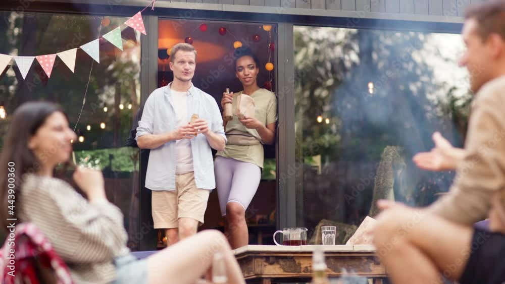 Onner Friend Male house owner appearing in doorway bringing beer for girlfriend and ...