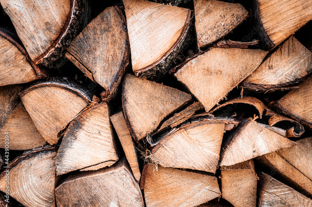 textured firewood background of chopped wood for kindling and heating the house. a woodpile with stacked firewood. the texture of the birch tree textured firewood background of chopped wood for kindling and heating the house. a woodpile with stacked firewood. the texture of the birch tree