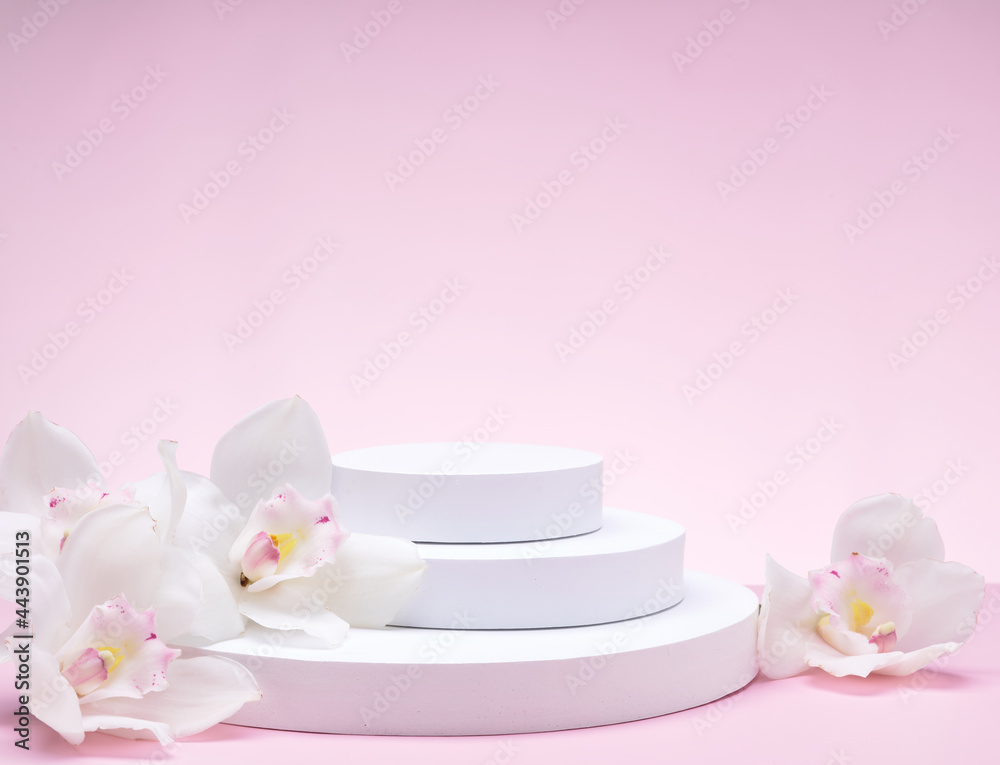 White geometric shapes podium for product display on pink background with orchid flowers and palm leaves. Monochrome stage, stand for product promotion in minimal style. 