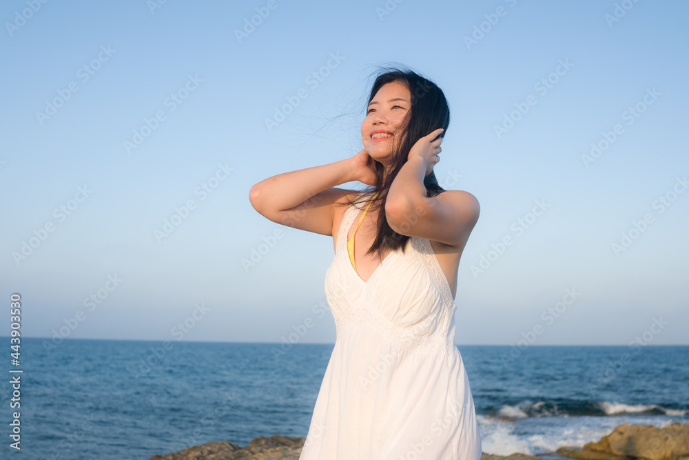holidays lifestyle portrait of young Asian woman by the sea - happy and beautiful Korean girl enjoying beach vacation trip relaxed and cheerful at beach rock cliff holidays lifestyle portrait of young Asian woman by the sea - happy and beautiful Korean girl enjoying beach vacation trip relaxed and cheerful at beach rock cliff