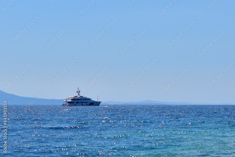 Ship in the sea. Marine yacht on the border of turquoise sea and blue sky on sunny day Ship in the sea. Marine yacht on the border of turquoise sea and blue sky on sunny day