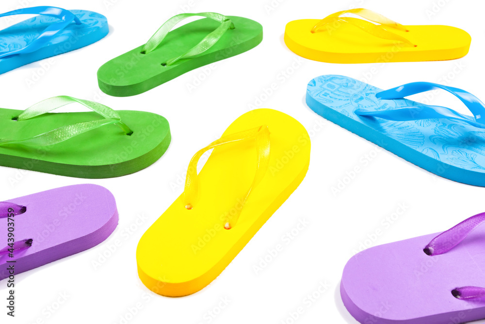 multi-colored rubber beach flip flops on a white background multi-colored rubber beach flip flops on a white background