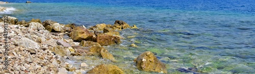 Stones on coast of azure sea. Focus on the center