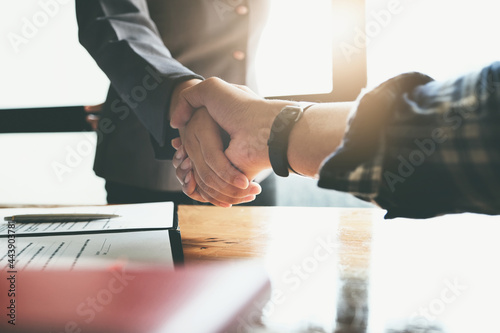 Focus on the congratulatory handshake. The real estate agent agrees to buy the home the customer at the agent's office. concept agreement. photo