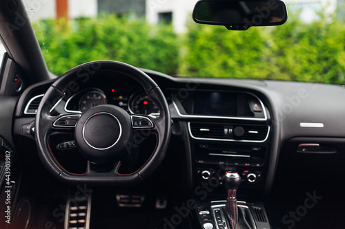 Expensive car interior with the steering wheel and multimedia dashboard © Moose
