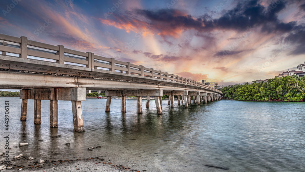 Sunset sky over bridge over Hickory Pass leading to the ocean in Bonita Springs