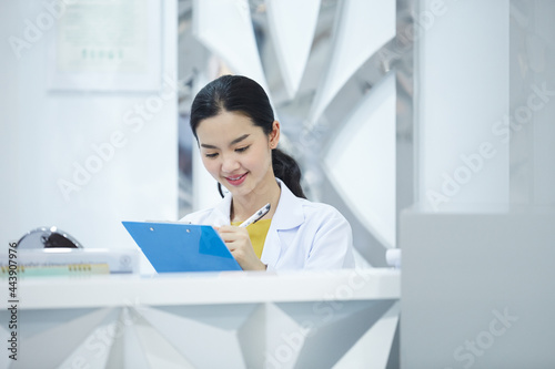 Portrait of young beauty doctor posing alone plastic surgeon's satisfied with positive feedback from her customers and smiling happily