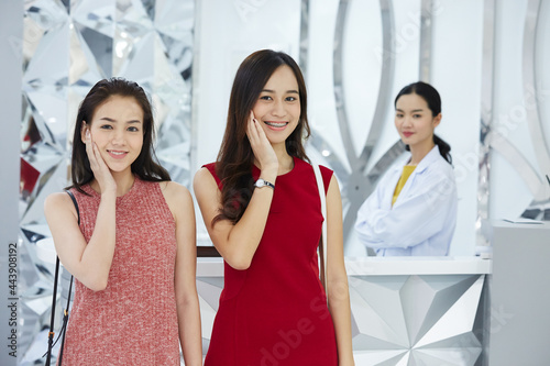 Portrait of young beauty doctor plastic surgeon's satisfied with positive feedback from her customers and smiling happily