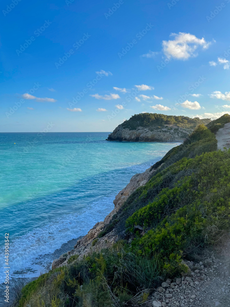Fototapeta premium Panorama with sea view. Landscape on the coast from cliffs. Turquoise-colored water with the horizon in the background.