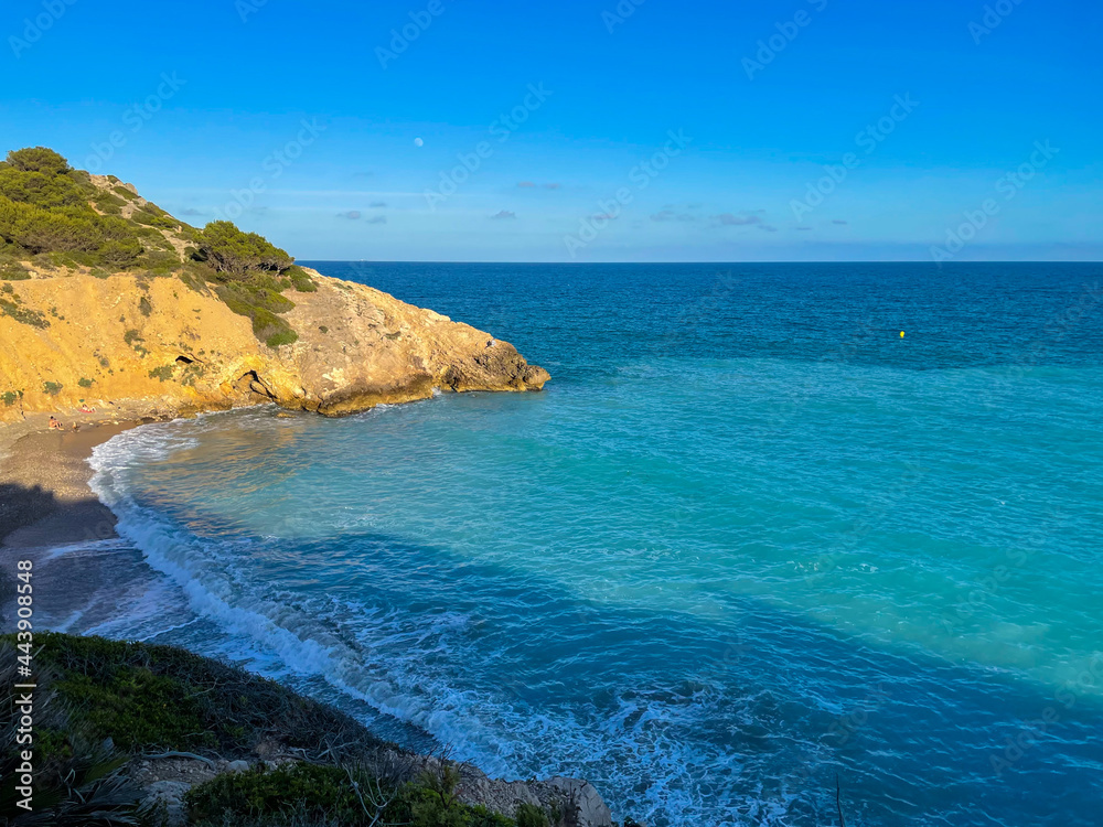 Panorama with sea view. Landscape on the coast from cliffs. Turquoise-colored water with the horizon in the background.