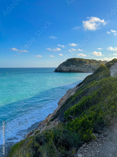 Panorama with sea view. Landscape on the coast from cliffs. Turquoise-colored water with the horizon in the background.