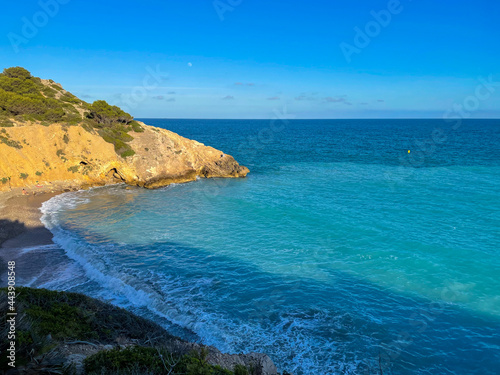 Panorama with sea view. Landscape on the coast from cliffs. Turquoise-colored water with the horizon in the background.