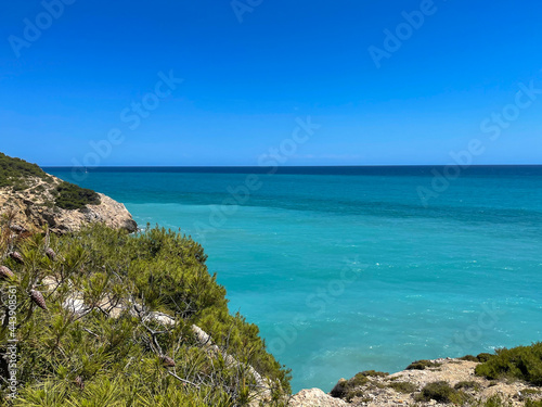 Fototapeta Naklejka Na Ścianę i Meble -  Panorama with sea view. Landscape on the coast from cliffs. Turquoise-colored water with the horizon in the background.