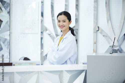 Portrait of young beauty doctor posing alone plastic surgeon's smiling happily and full of confidence after conducting the cosmetic surgery for her customer