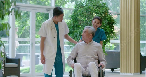 Young doctor talking with senior man in nursing home,4K