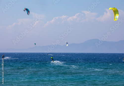 happy surfing on a windy day on the mediterranean sea, near the island of Rhodes, horizontal.