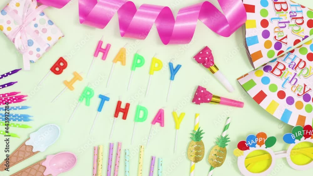 Happy birthday candles appear inside of frame made of party decorations. Stop motion Happy birthday candles appear inside of frame made of party decorations. Stop motion