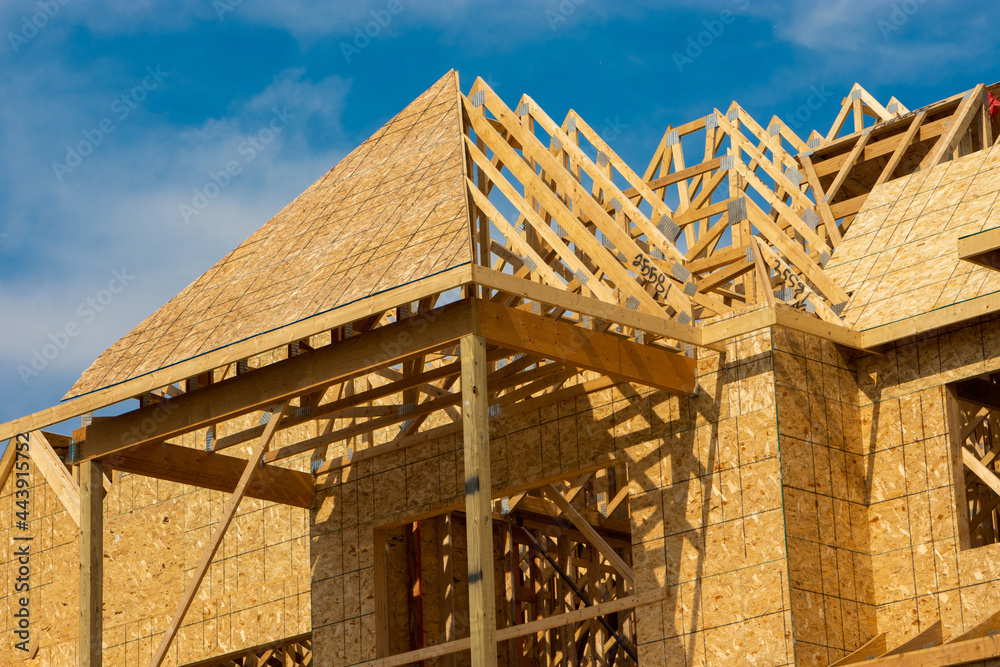 Obraz premium Different views of spacious 2 story wood frame luxury home under construction.