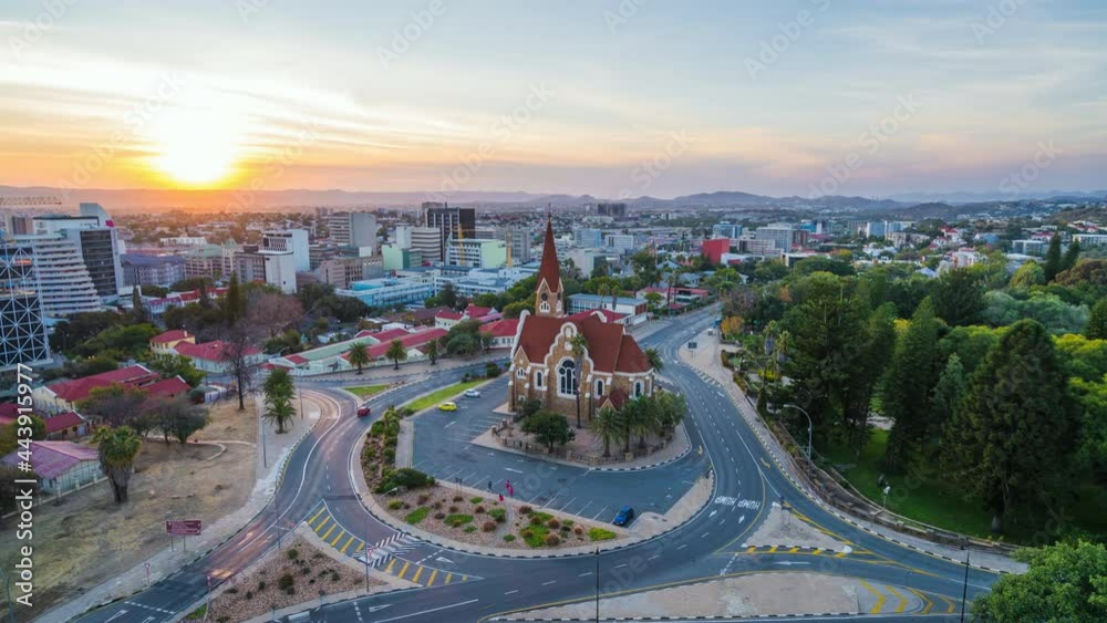Day to night timelapse view of traffic around historic landmark Christ Church aka Christuskirche in Windhoek, the capital and largest city of Namibia.	