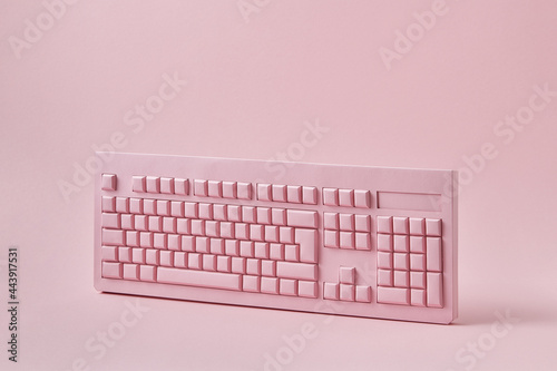 Vertically standing papercraft pink keyboard.