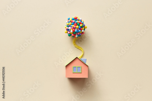 Beige papercraft house model with balloons photo