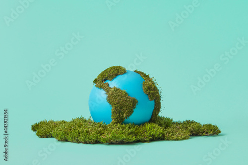 Earth globe on green moss