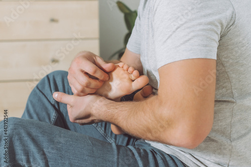 Dad holds and tickles feet of kid. Boy plays with his father. Family, having fun at home