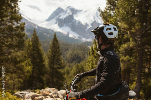 Mountain biker into the high mountains photo