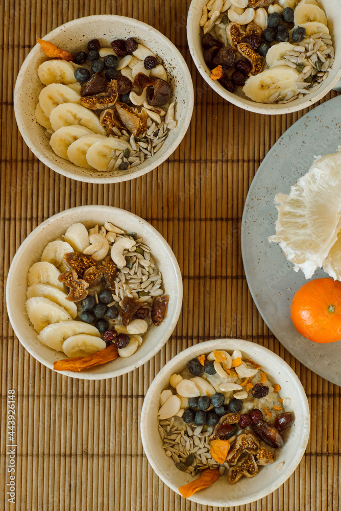 Healthy breakfast with bananas, nuts, berres and oatmeal Healthy breakfast with bananas, nuts, berres and oatmeal