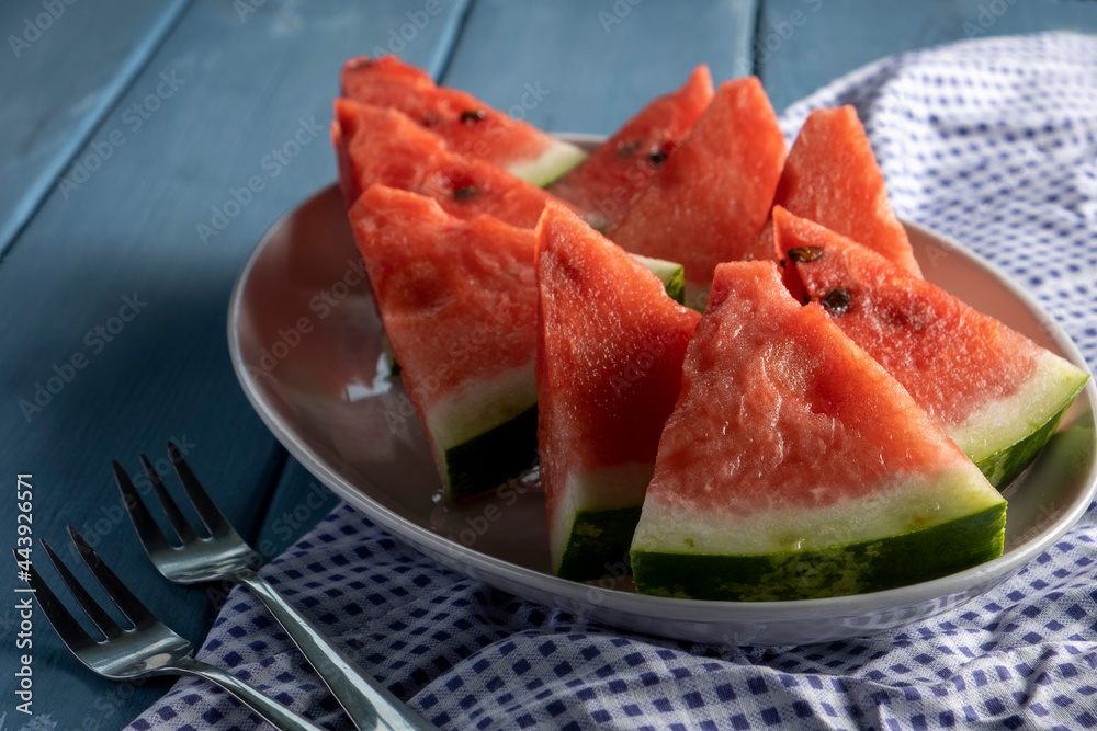 Sliced watermelon. Slices on rustic blue table. Copy space. Sliced watermelon. Slices on rustic blue table. Copy space.