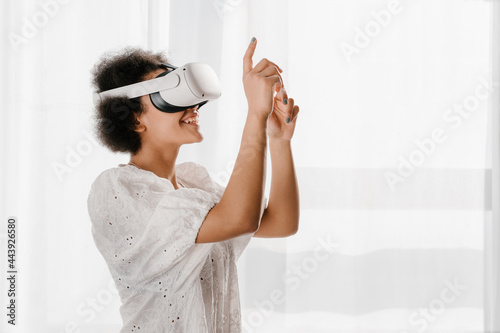 Black female in VR glasses interacting with cyberspace photo