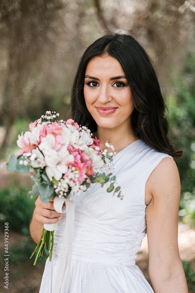 Young bride with bouquet in the forest Young bride with bouquet in the forest