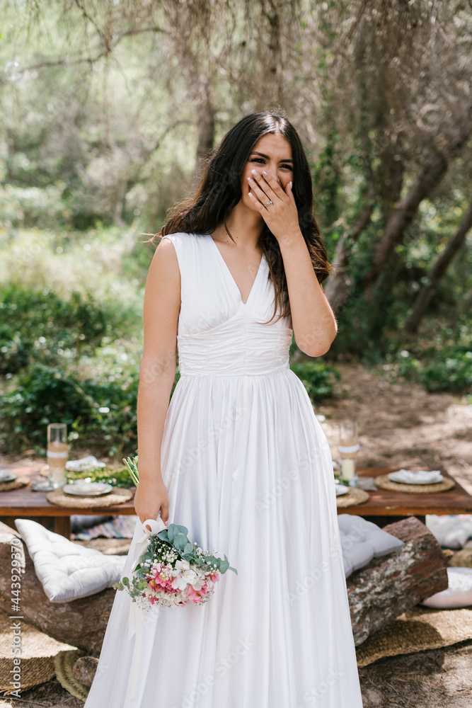 Happy bride with bouquet in forest Happy bride with bouquet in forest