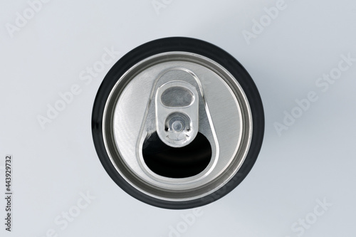 Detail shot from above of the spout of an aluminum can on a white background and selective focus.